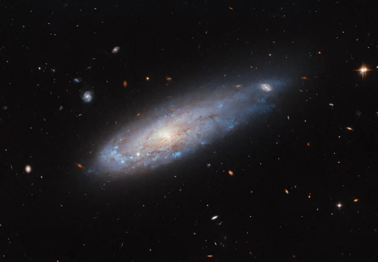 Hubble Captures Stunning Image of Spiral Galaxy IC 3225 Zooming Through Space